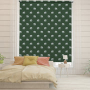 Green blackout window blind with small grey elephant silhouettes repeating on a deep forest green ground - Lolli & Omi